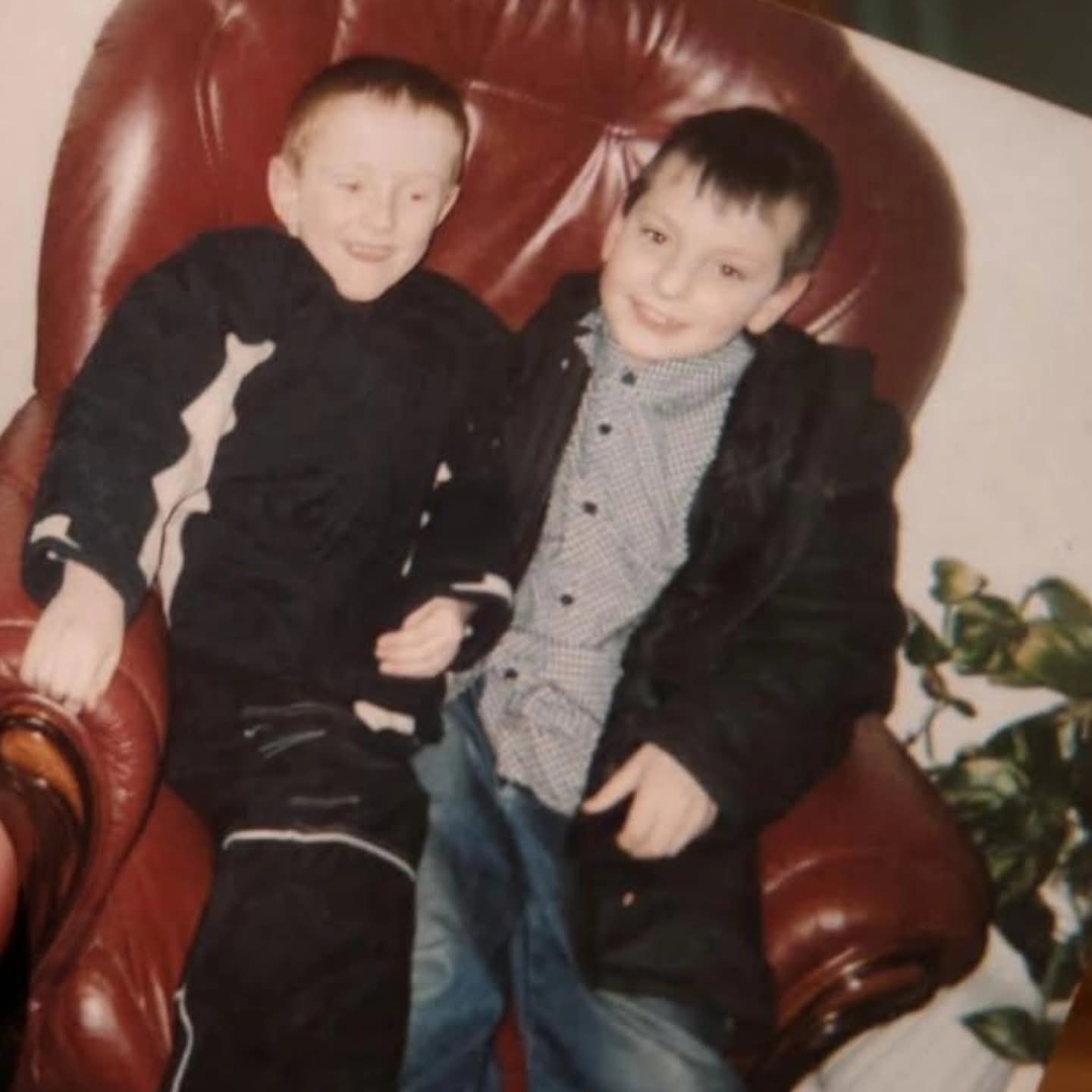 Older family photograph of Justin with another child seated together